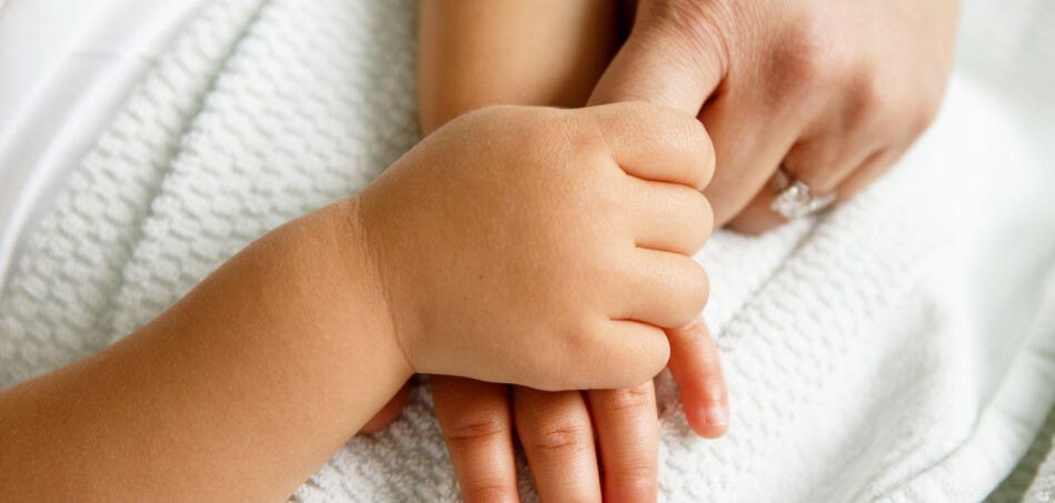 Child holding an adult hand